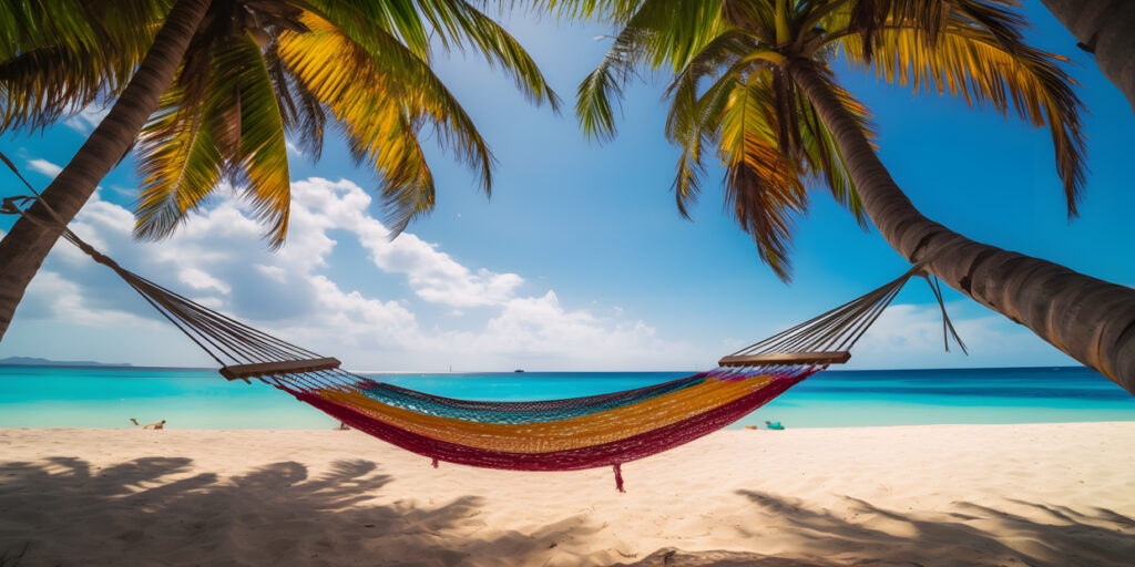 colorful hammock hangs between two palm trees with a trop